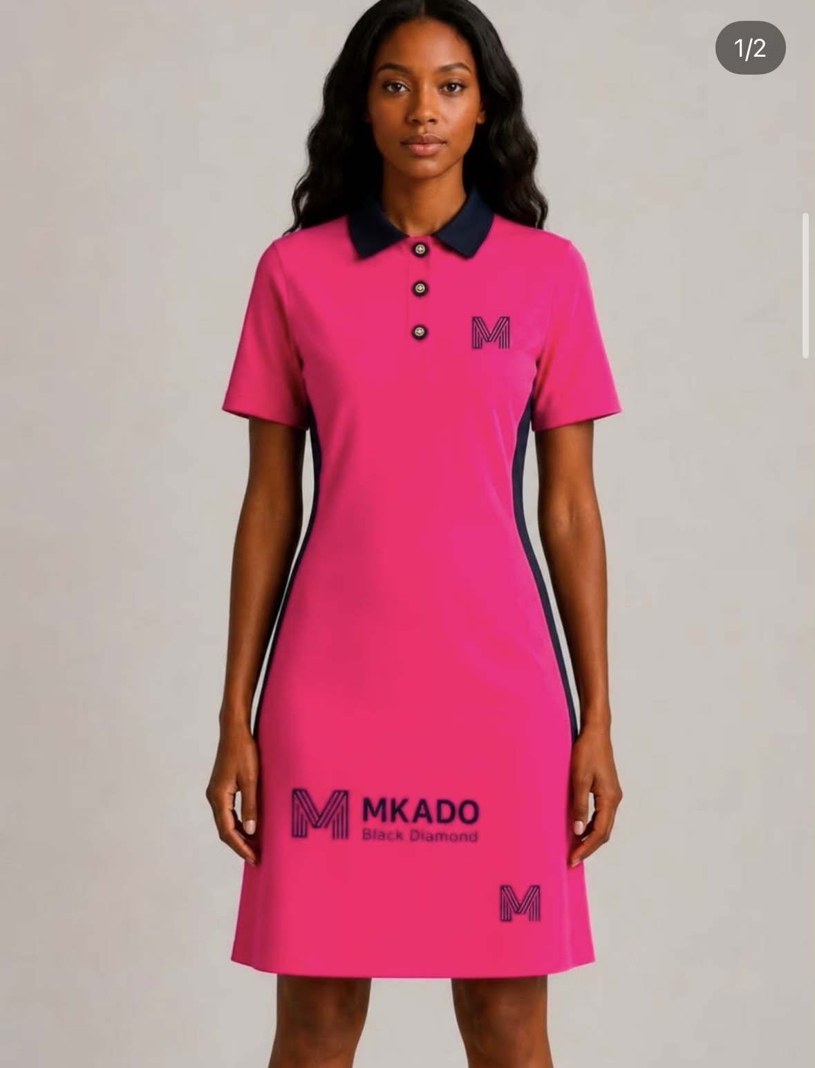 Model in a pink MKADO Black Diamond golf polo dress with navy collar and side panels